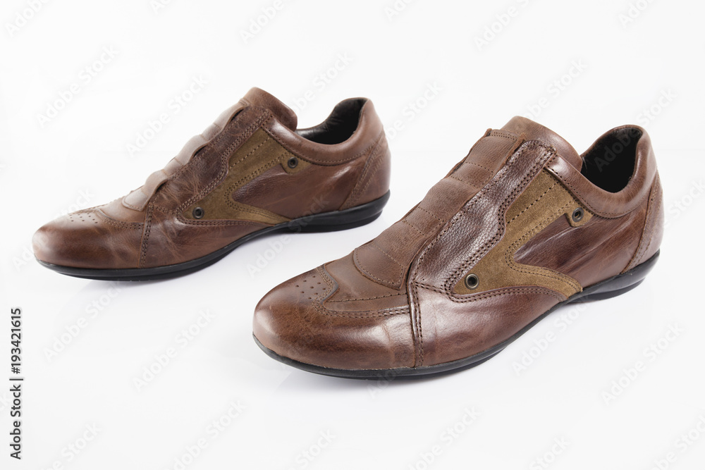 Male brown leather shoe on white background, isolated product, comfortable footwear. Male brown leather shoe on white background, isolated product, comfortable footwear.