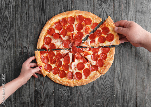 Hand pulls pizza