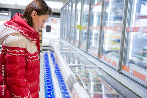 girl makes a purchase at the grocery hypermarket