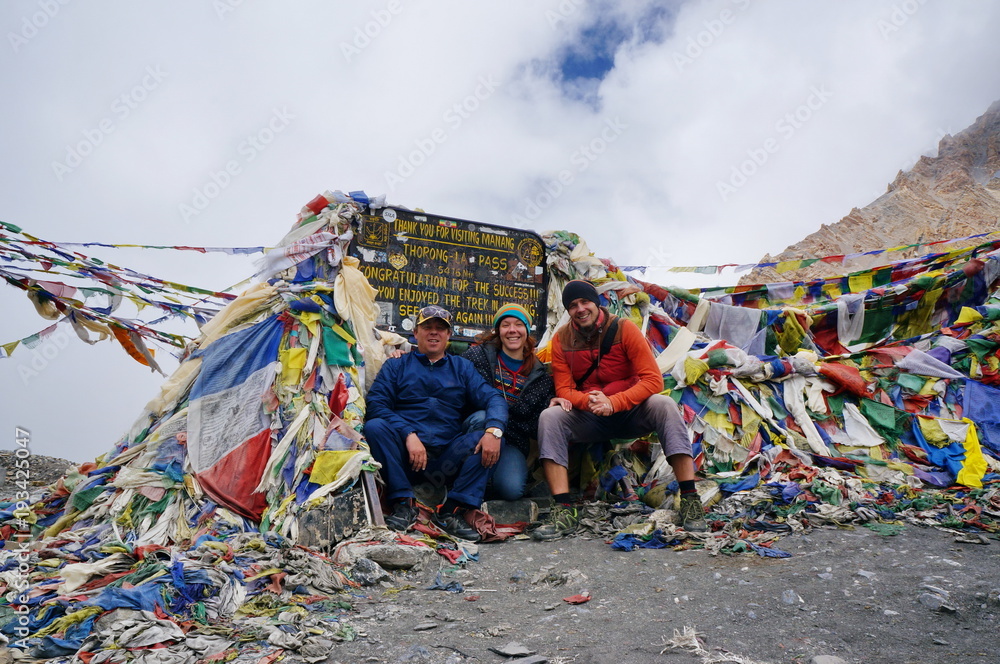 Tourists are sitting on the Thorong-La Pass (5416m), the highest pass in the world. Himalayas. Nepal.