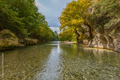 wild Acheron river in Greece with clouds and vegetation