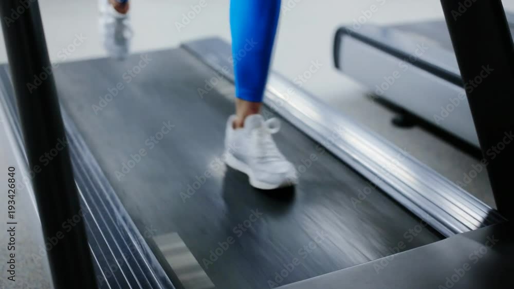 feet run along the treadmill close up feet run along the treadmill close up