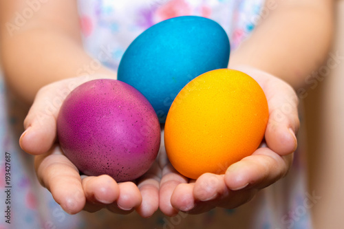 Easter eggs hand. Child hold colorful painted eggs in his hands.