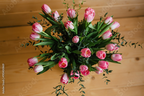 A bouquet of pink tulips in a beautiful crystal vase