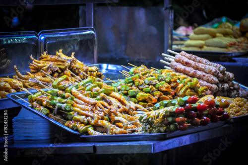 street foods with legs of chicken, pork, beef, and vegetavles