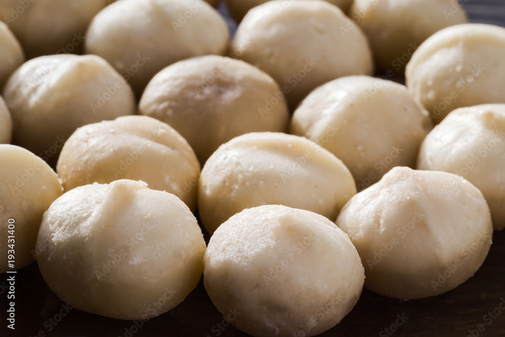 A handful of kernels of macadamia nuts close-up. Selective focus. A handful of kernels of macadamia nuts close-up. Selective focus.