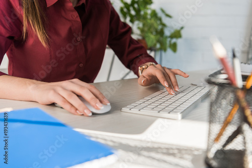cropped shot of manageress working with computer