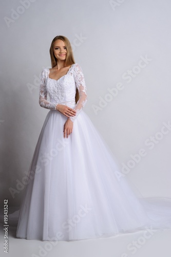 Beautiful bride in wedding dress, white background