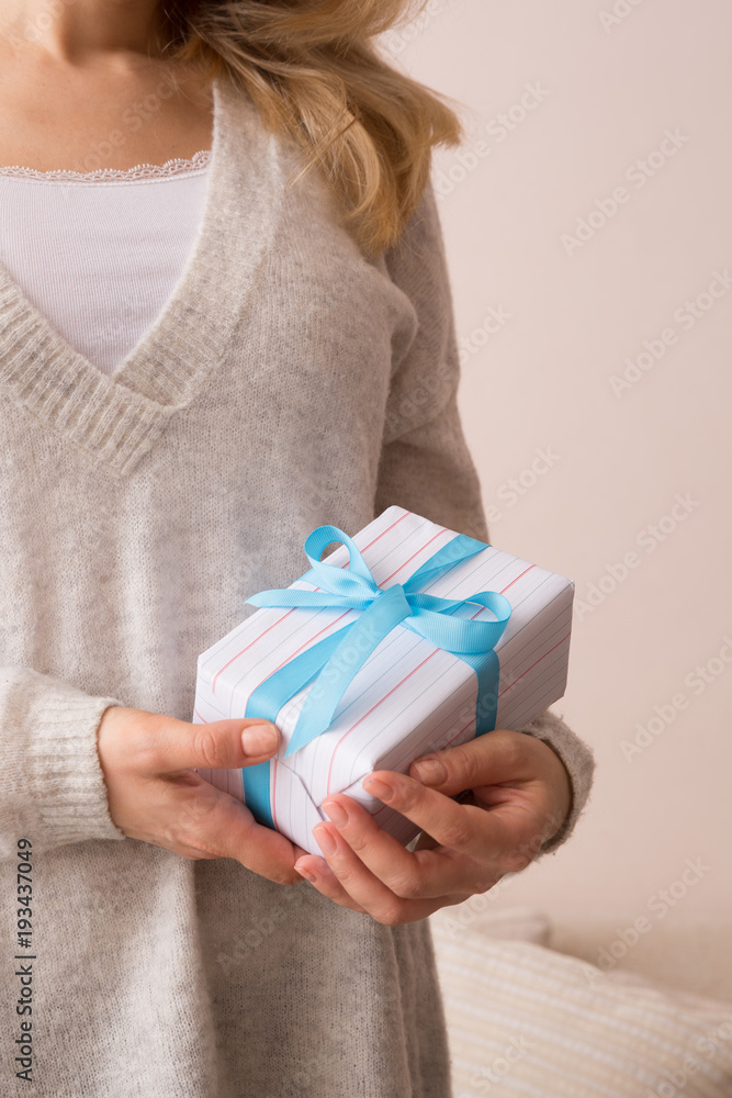 Closeup of young girl's hands holding nicely wrapped Christmas, birthday or any other celebration gift. Closeup of young girl's hands holding nicely wrapped Christmas, birthday or any other celebration gift.