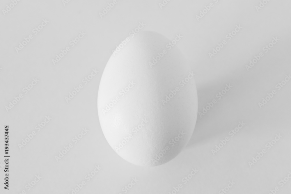 White egg on white background. Minimal concept. White egg on white background. Minimal concept.