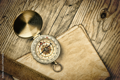 Vintage paper with compass on old wooden boards