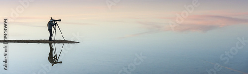 Silhouette and reflection of photographer in Bahariya salt lake