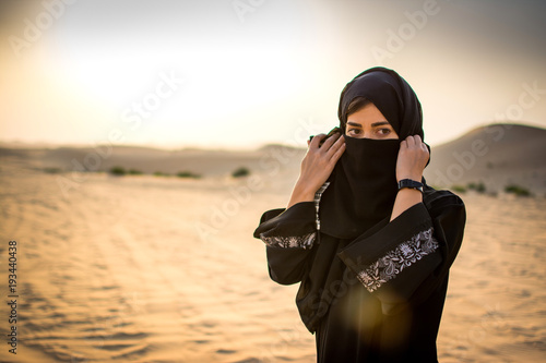Photography Portrait of a young Arab woman wearing traditional clothing in the desert