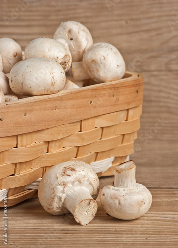 Basket with mushrooms on wooden background