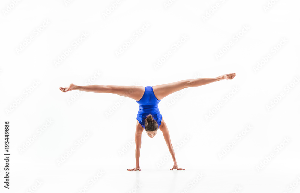young sporty woman doing acrobatic exercise