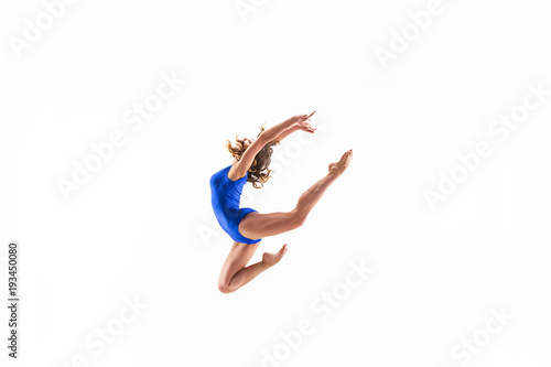 young sporty woman doing acrobatic exercise