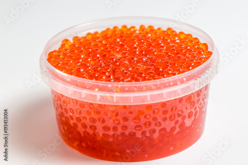 red caviar salmon in a jar on a white background