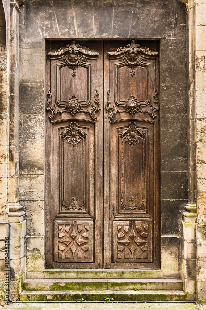 Ancient wooden entrance door to the Basilica of Saint Denis. Saint-Denis, France