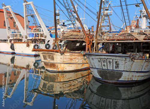 fishing boats moored in the water canal by the sea