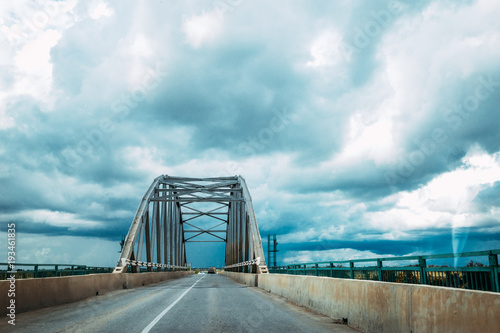 road through a metal bridge for cars