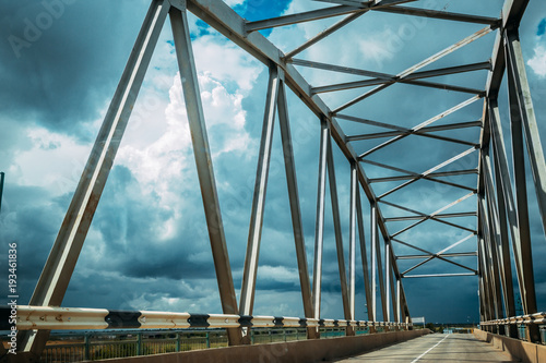 road through a metal bridge for cars