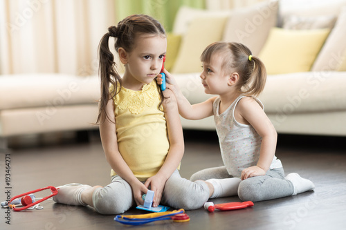 Two kids, funny toddler gir...