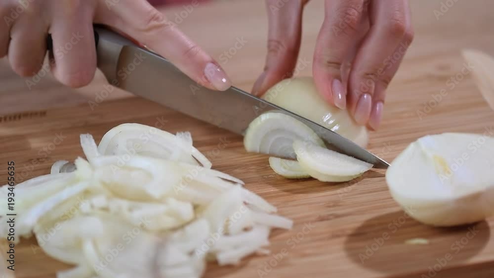 Chef slices the onion. Knife, cutting Board, onion. Chef slices the onion. Knife, cutting Board, onion.