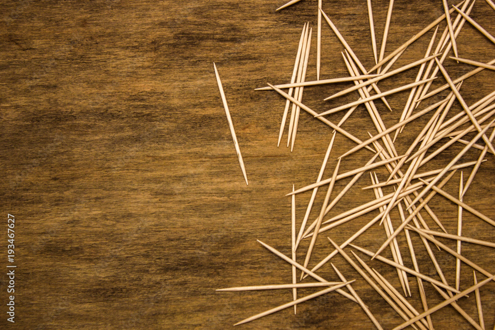 many toothpicks on the brown table background many toothpicks on the brown table background