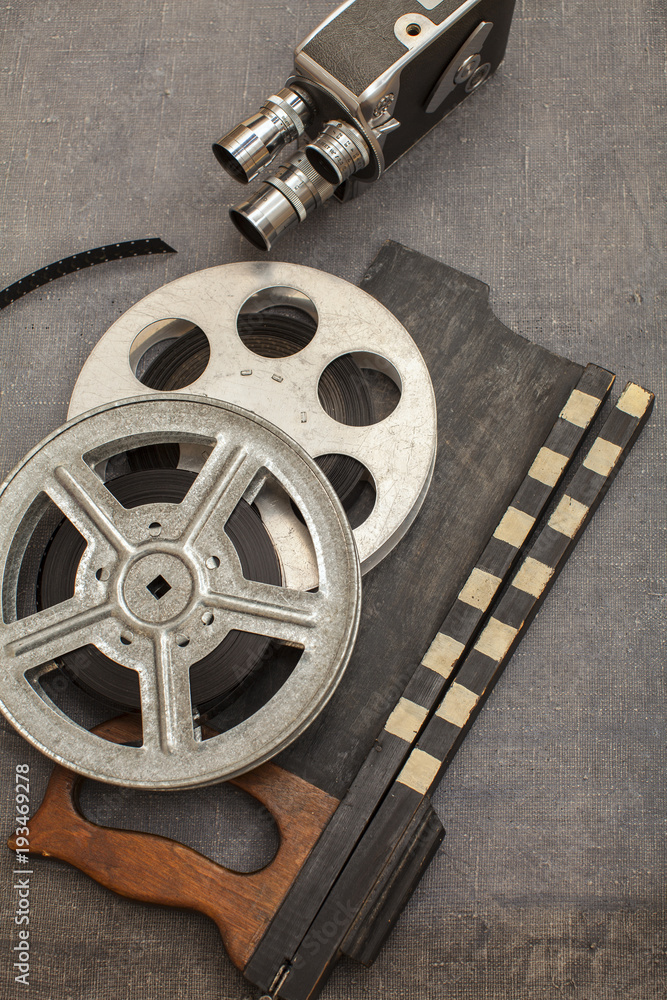 Old movie camera, film reels and clapperboards Stock Photo