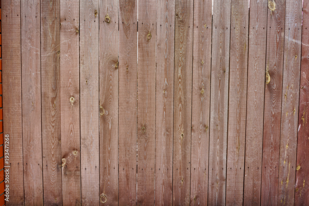 Fototapeta premium Vintage wooden fence with traces of old paint, scuffs and scratches. Photo close-up 