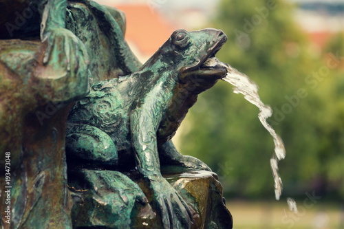 Frog splashing water on fountain, water scarcity concept, Petrin, Prague photo