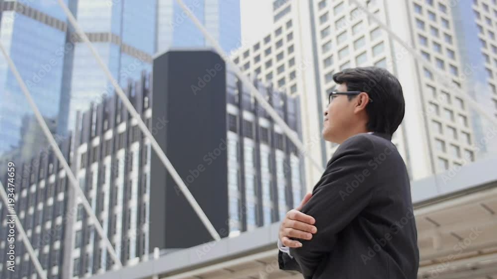 Steadicam shot of a confident businessman in suit observing the cityscape Steadicam shot of a confident businessman in suit observing the cityscape