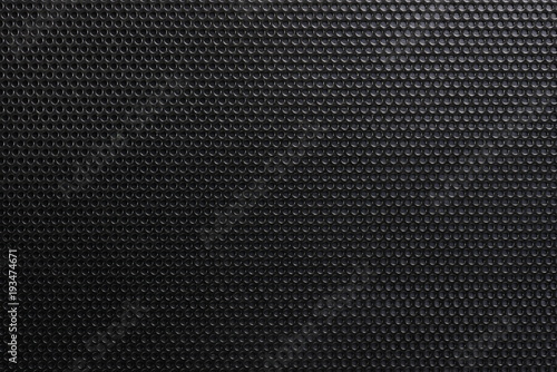 Pattern of dark metal background with holes