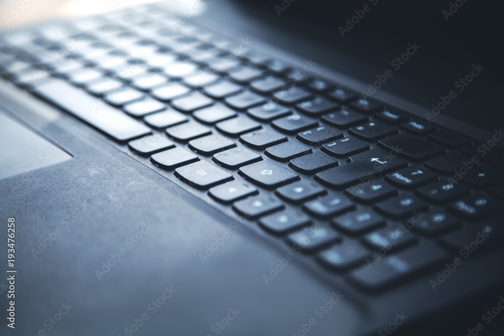 Black laptop keyboard background.