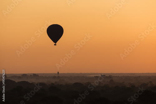 Scenic sunrise with a hot air balloon above Bagan in Myanmar. © Fredy Thürig