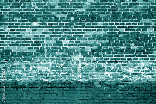 Weathered brick wall background in cyan tone.