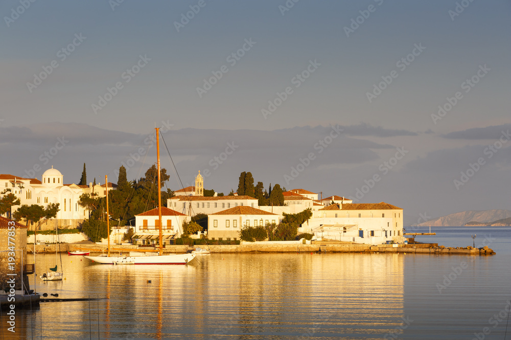 Houses and a church in the harbor of Spetses village, Greece. 
