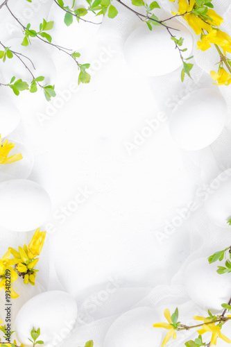 Spring Easter background with white eggs forsythia flowers