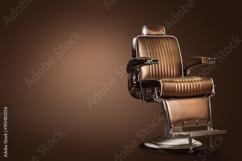 Stylish Vintage Barber Chair Isolated On Brown Background. Barbershop Theme