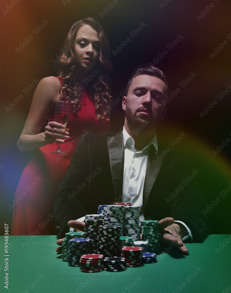 woman and man at the poker table with chips and drinks woman and man at the poker table with chips and drinks