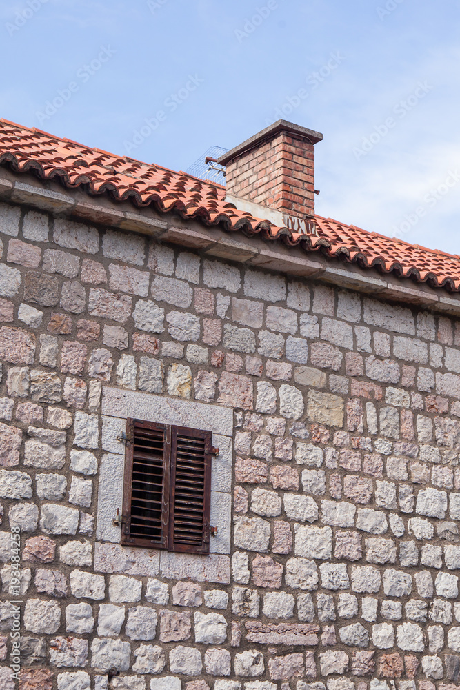 old stone wall of a building with a window. Montenegro old stone wall of a building with a window. Montenegro