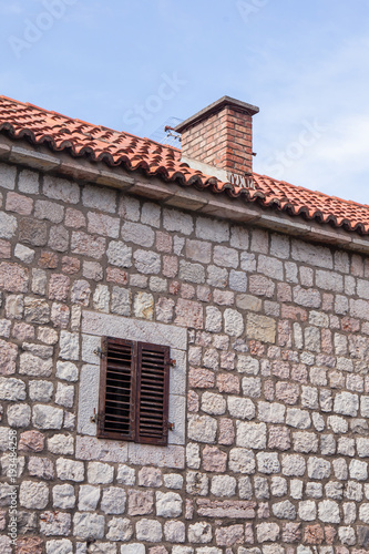 old stone wall of a building with a window. Montenegro