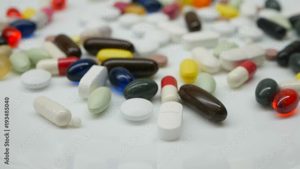 Close up, around rotating with colorful pills Close up, around rotating with colorful pills