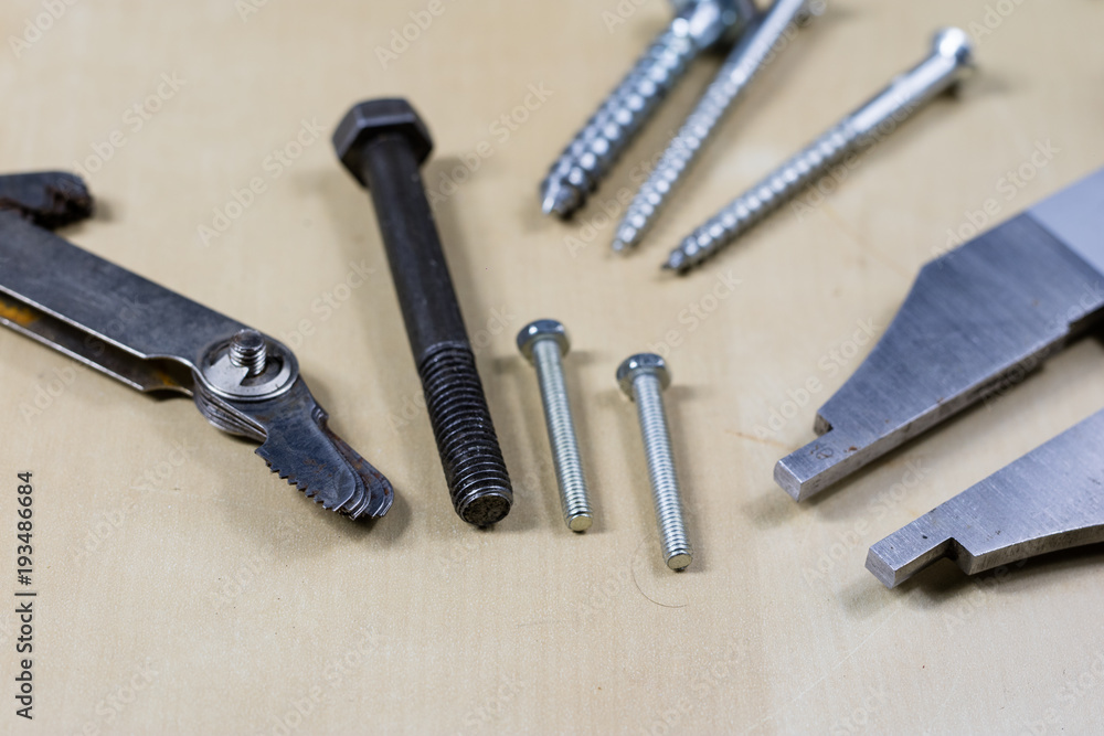 Tools and measuring accessories on a wooden workshop table. Making control measurements using calipers, micrometers and other measuring tools. Tools and measuring accessories on a wooden workshop table. Making control measurements using calipers, micrometers and other measuring tools.