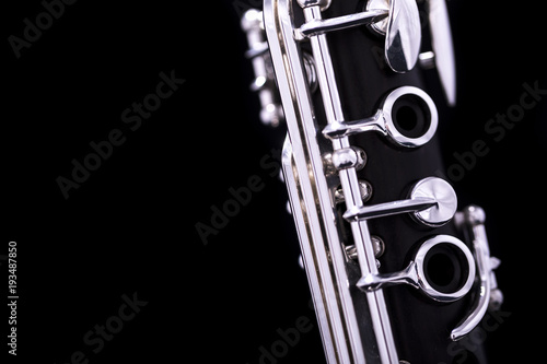Vászonkép A new silver plated clarinet on a black background