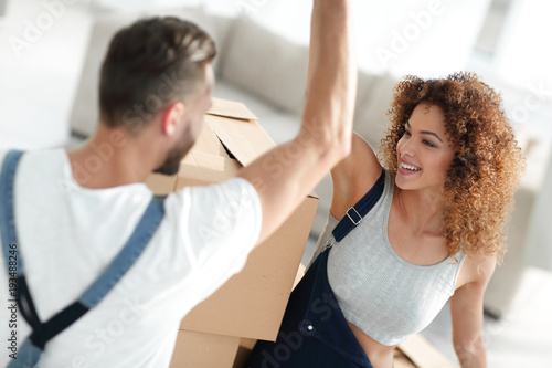 young couple giving five when moving to a new apartment