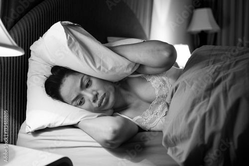 Sadly depressed women suffer from insomnia, she sleep in bed and touching her forehead, sleep disorder and stress concept.