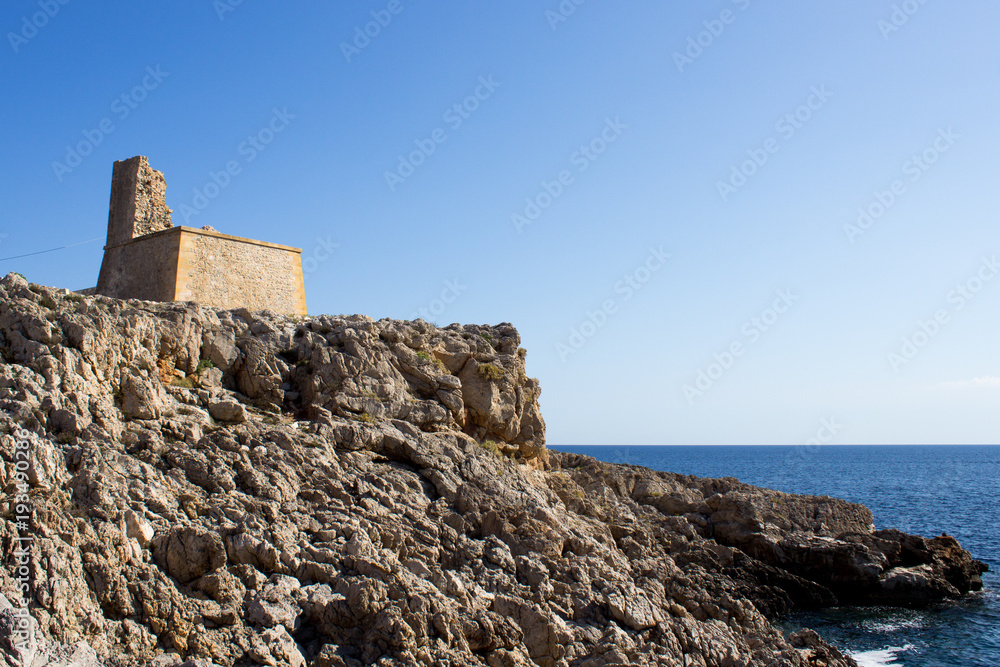Ruins on the rocky coast with mediterranean sea in background in San Vito lo Capo, Sicily, Italy
