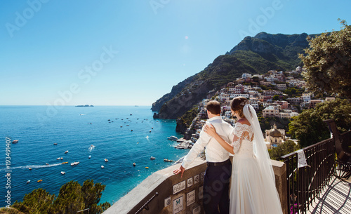 Tender romantic young couple in honeymoon after wedding in Positano, Amalfi coast, Italy