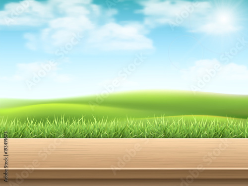 Empty wooden table on landscpe with grass background. Deck made of wooden planks. Template for a variety of products. photo